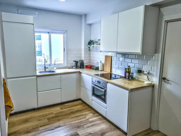 Modern white kitchen with wooden countertops